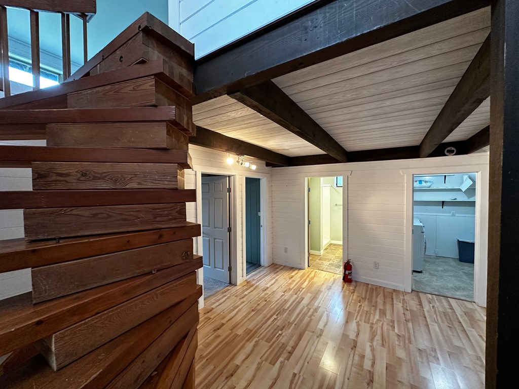 a view of a living room from a staircase with wood floors