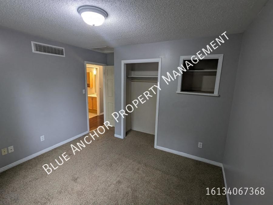 a bedroom with a closet and a door to a bathroom
