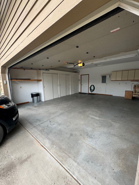 an empty garage with a car parked in it