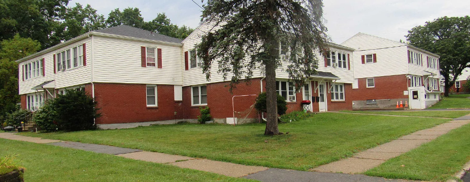 a row of houses on a street with a tree in the front