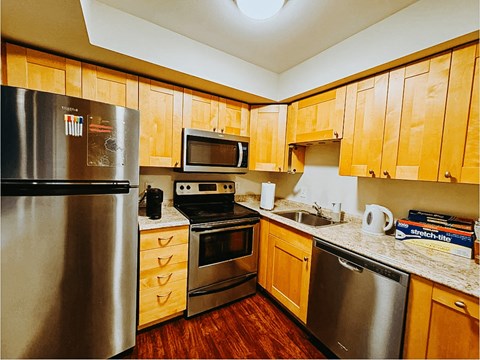 a kitchen with stainless steel appliances and wooden cabinets