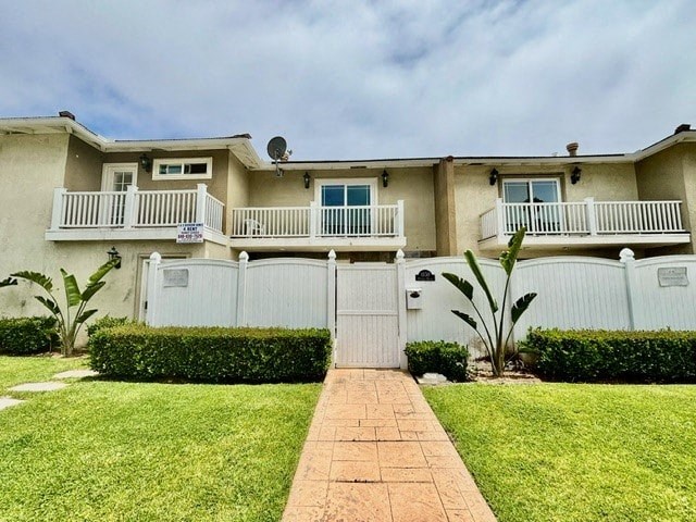 a house with a yard and a white fence