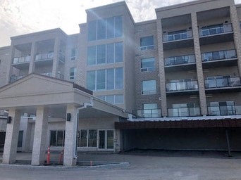 A large building with a covered walkway in front.