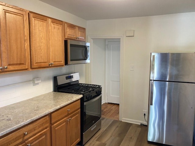a kitchen with stainless steel appliances and wooden cabinets
