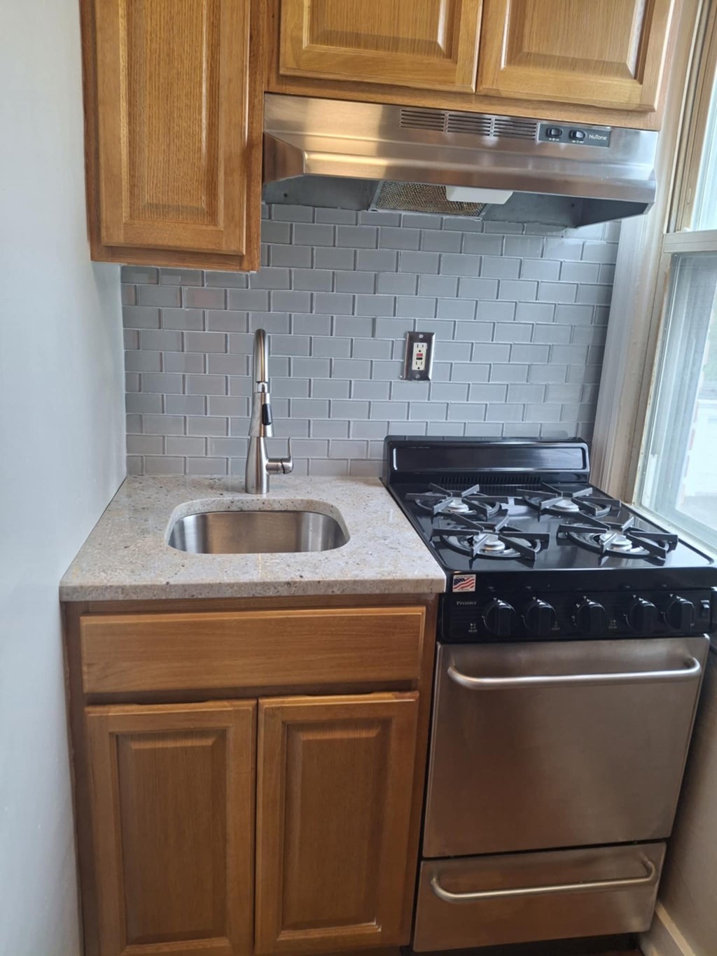 A kitchen with a stove and a sink.