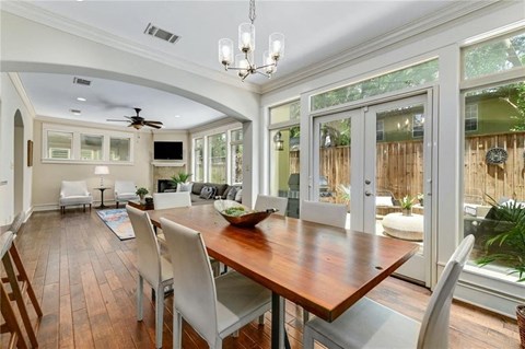 a dining room with a wooden table and chairs