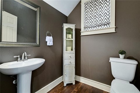 a bathroom with a sink toilet and a mirror