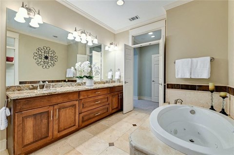 a large bathroom with a large tub and a sink