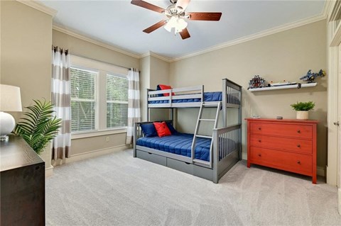 a bedroom with a bunk bed and a ceiling fan