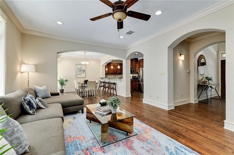 a living room with furniture and a ceiling fan