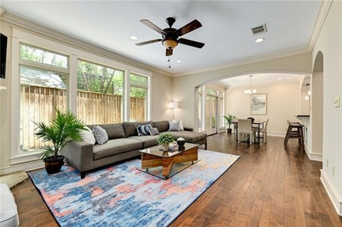 a living room with a couch and a ceiling fan