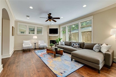 a living room with a couch and a ceiling fan