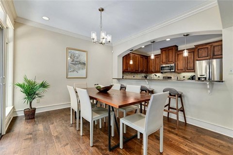 a dining room with a wooden table and chairs
