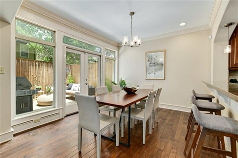 a dining room with a table and chairs and a window