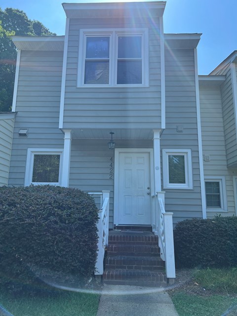 A house with a white door and two windows.