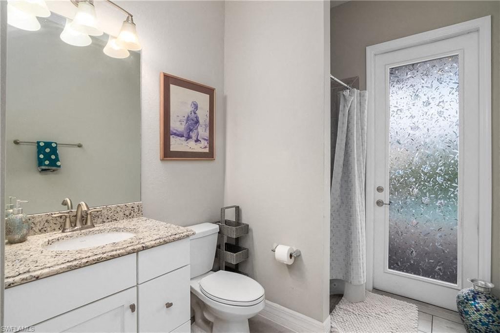 a bathroom with a toilet sink and a shower