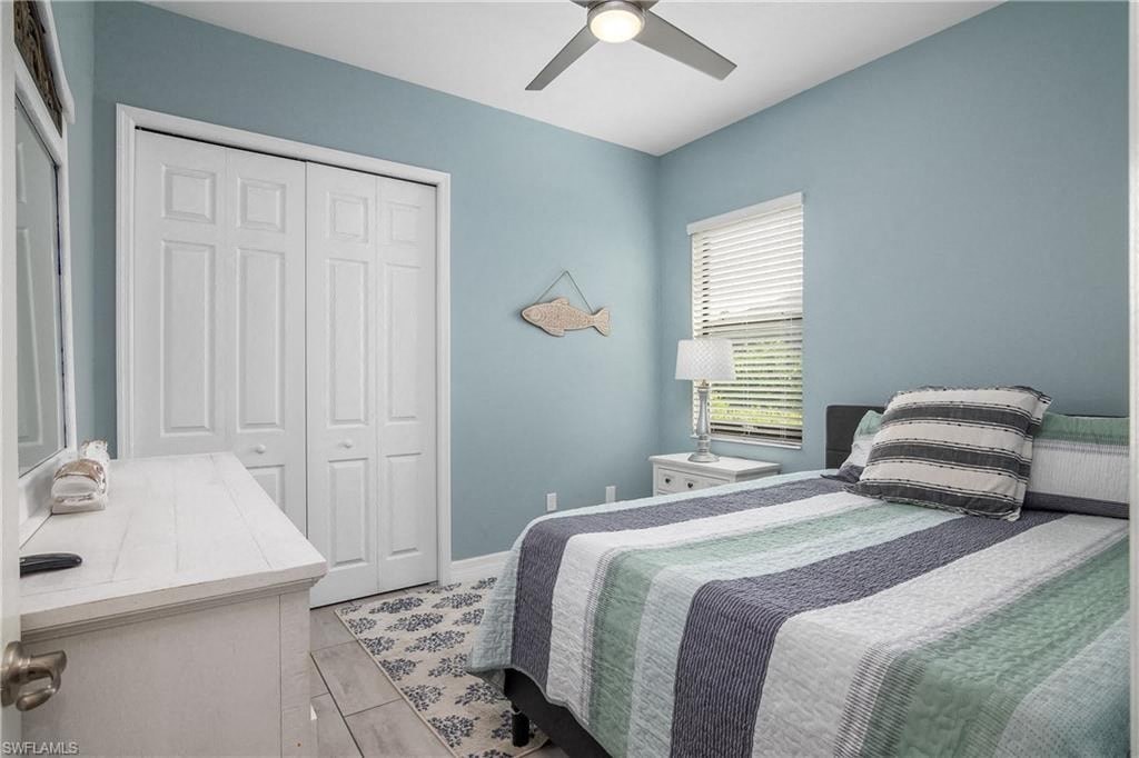 a bedroom with a bed and a ceiling fan