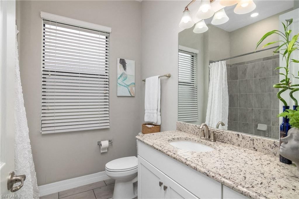 a bathroom with a sink and a toilet and a mirror