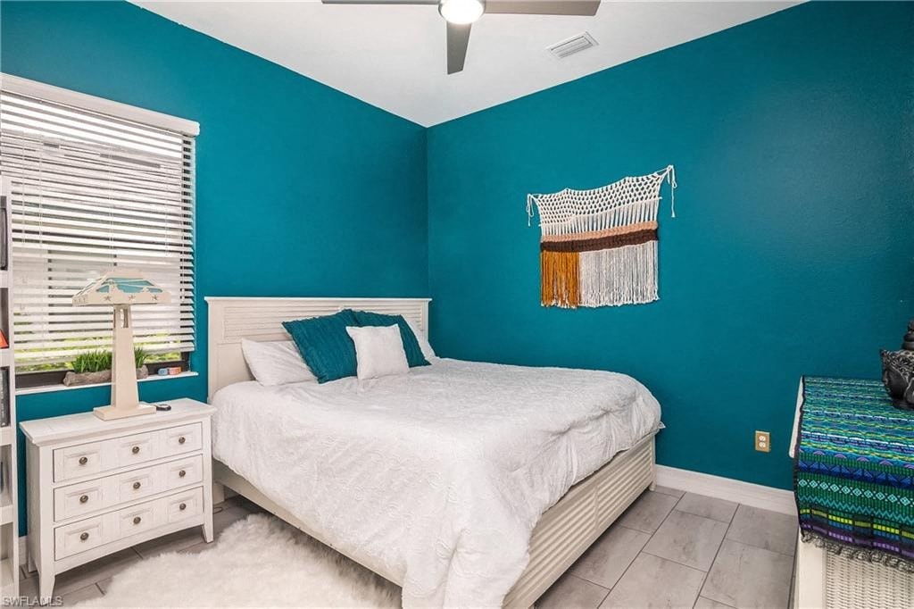 a bedroom with a white bed and a blue wall