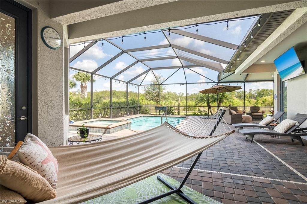 a porch with a hammock and a swimming pool
