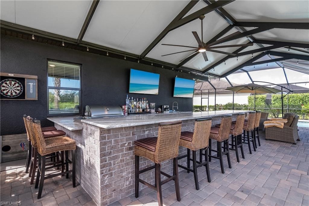 a bar with bar stools and chairs in a patio