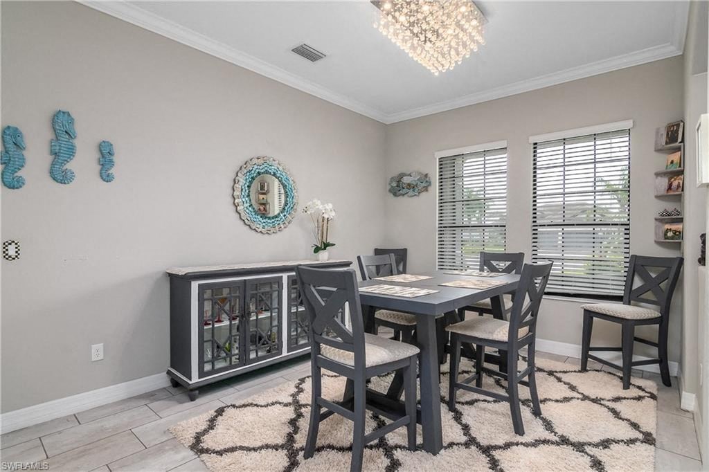 a dining room with a table and chairs and a chandelier