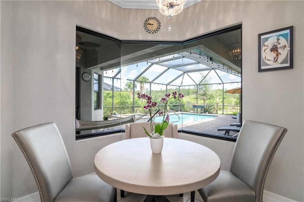 a dining room with a view of a pool