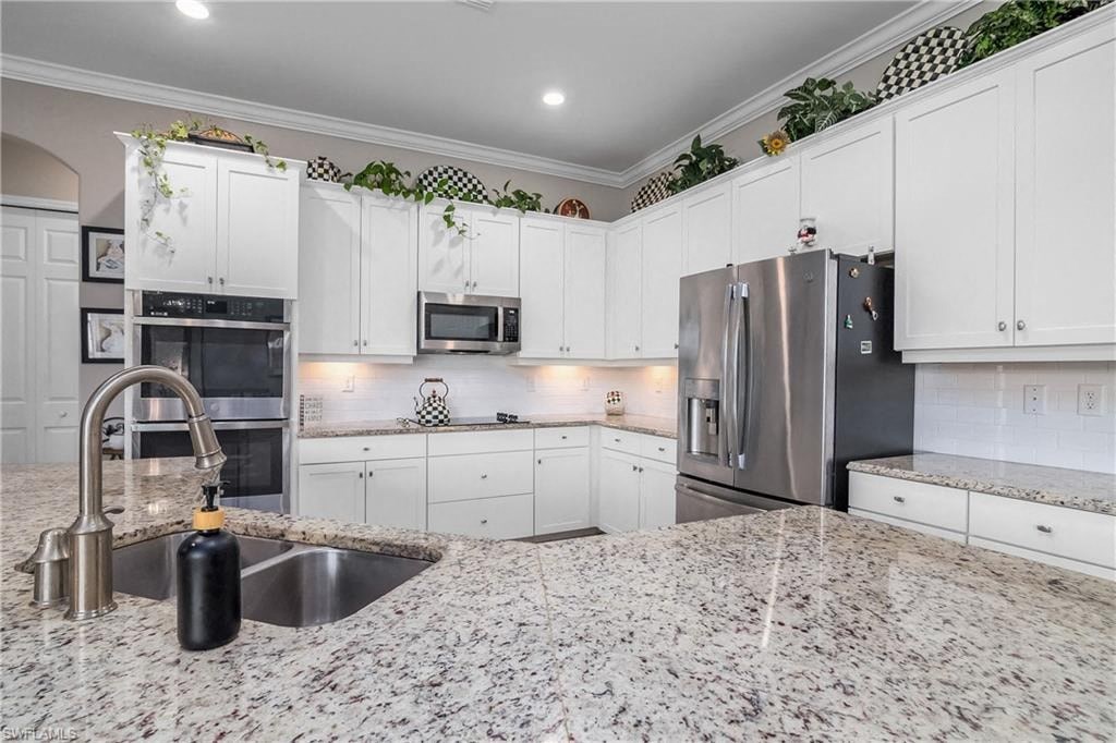 a kitchen with granite counter tops and a sink