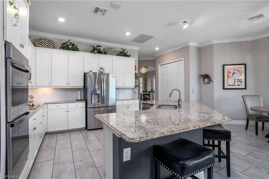 a large kitchen with a marble counter top