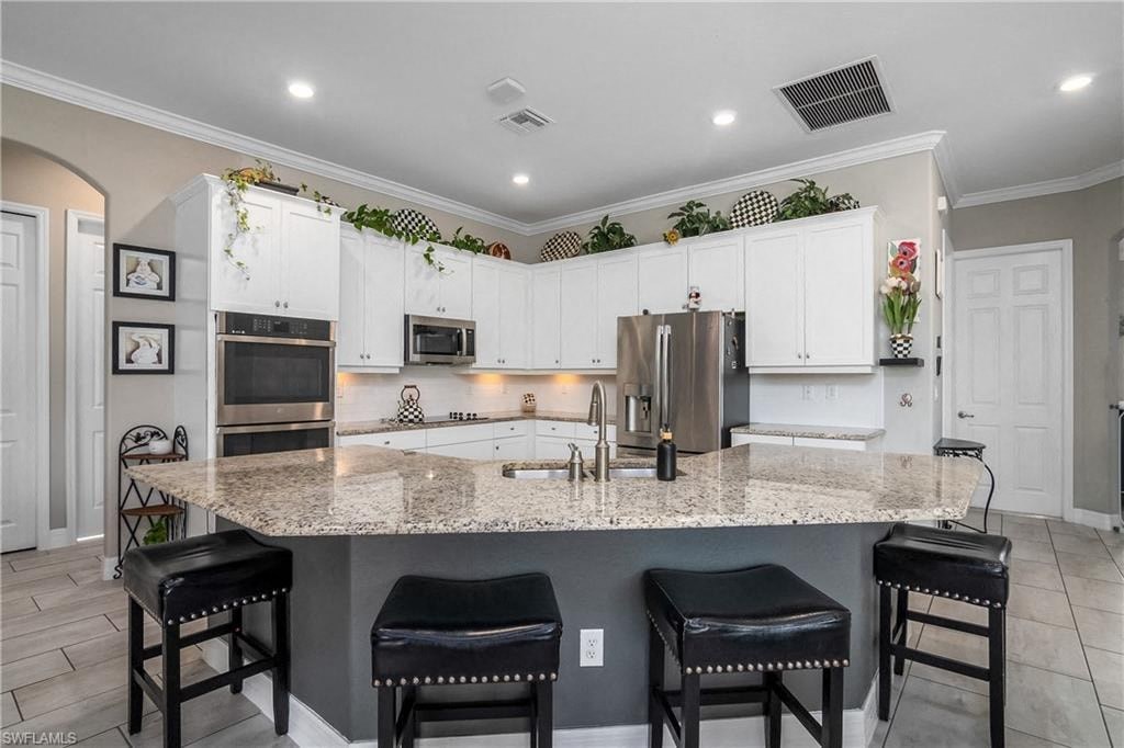 a large kitchen with a marble counter top