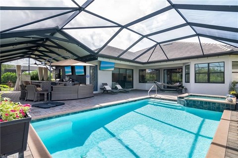 the pool and living area of a house with a pool