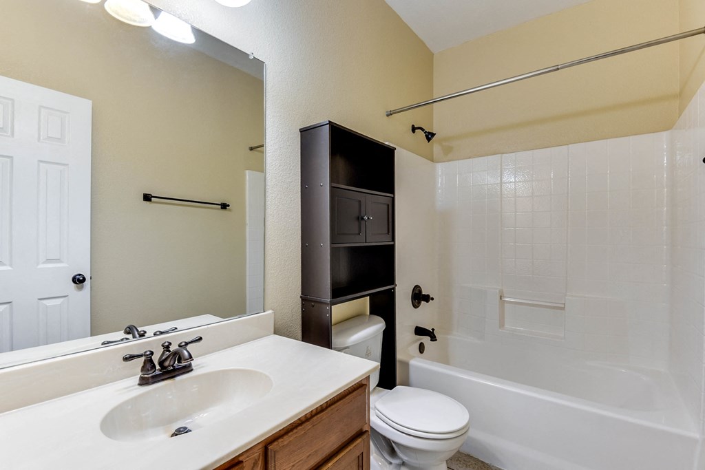 a bathroom with a sink toilet and a tub