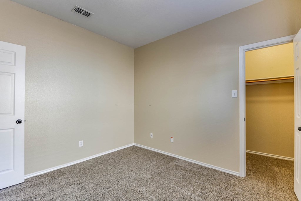 a empty room with a door to a closet