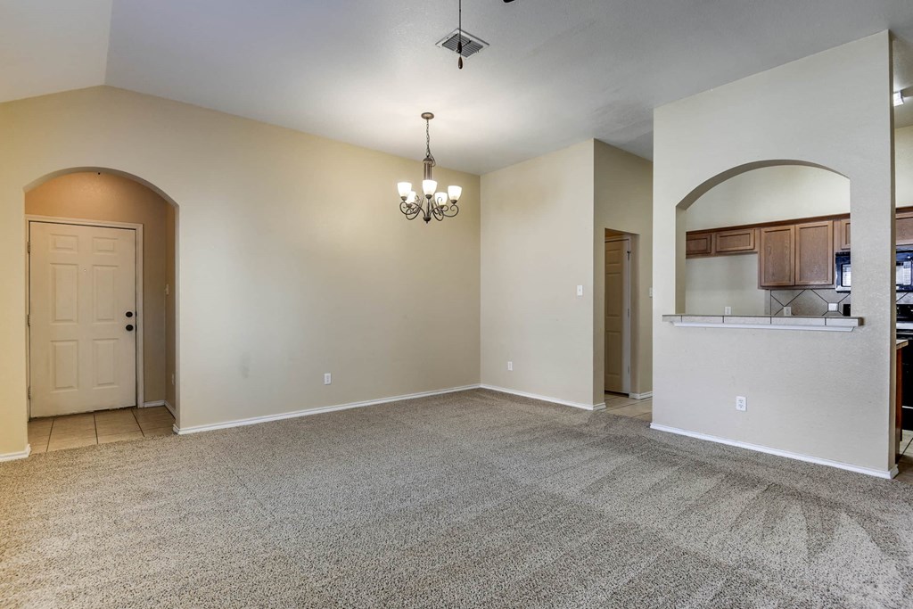 the living room and kitchen of a new home with no furniture