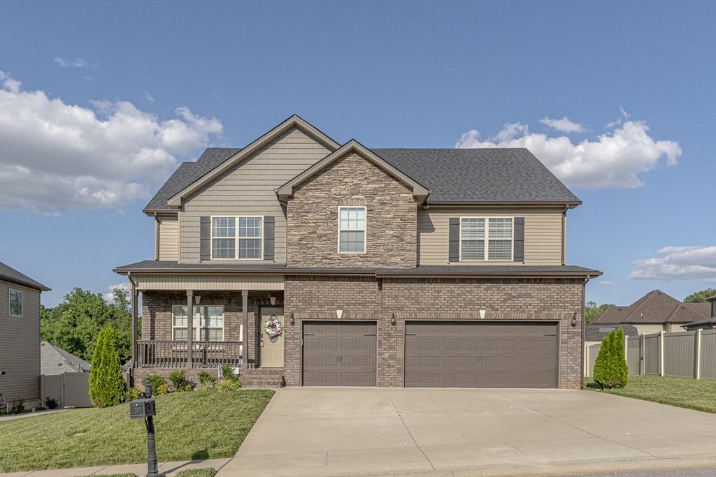 a house with two garage doors and a driveway