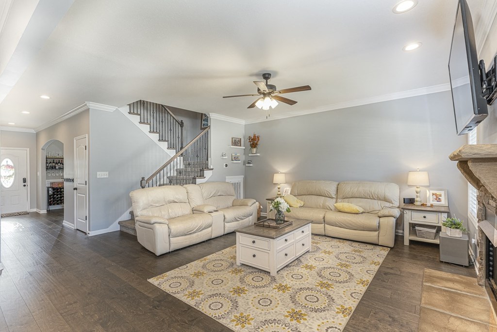 a living room with two couches and a ceiling fan