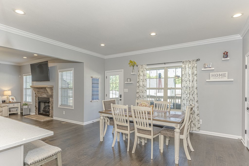 a dining room with a table and chairs and a fireplace