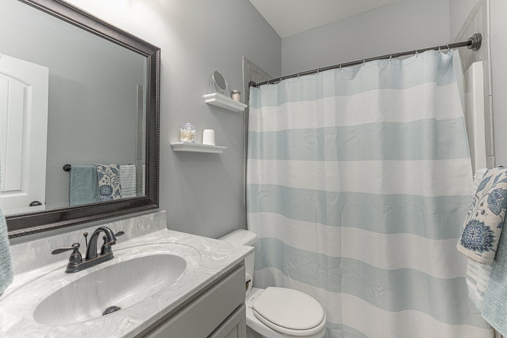 a bathroom with a shower curtain and a sink