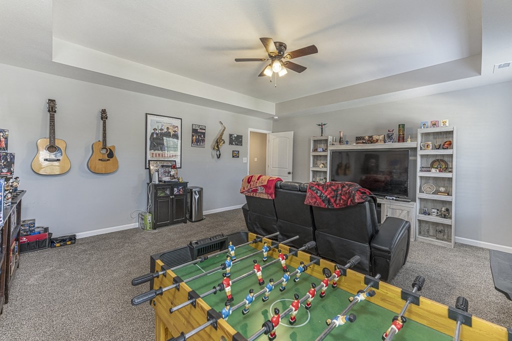 the living room has a foosball table and a couch