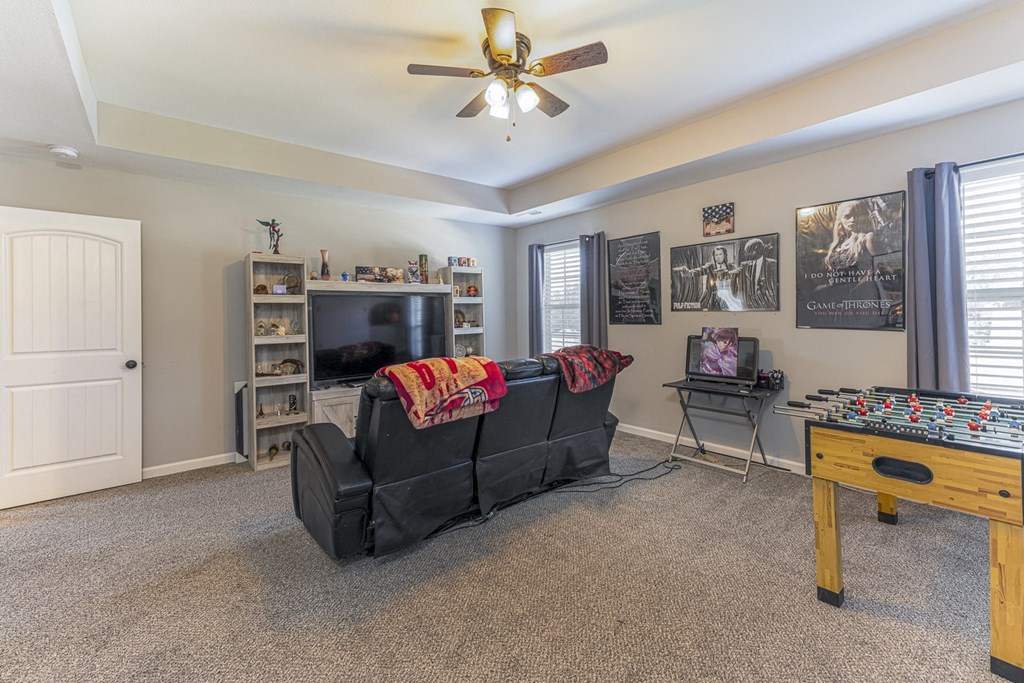 a living room with a couch and a game table