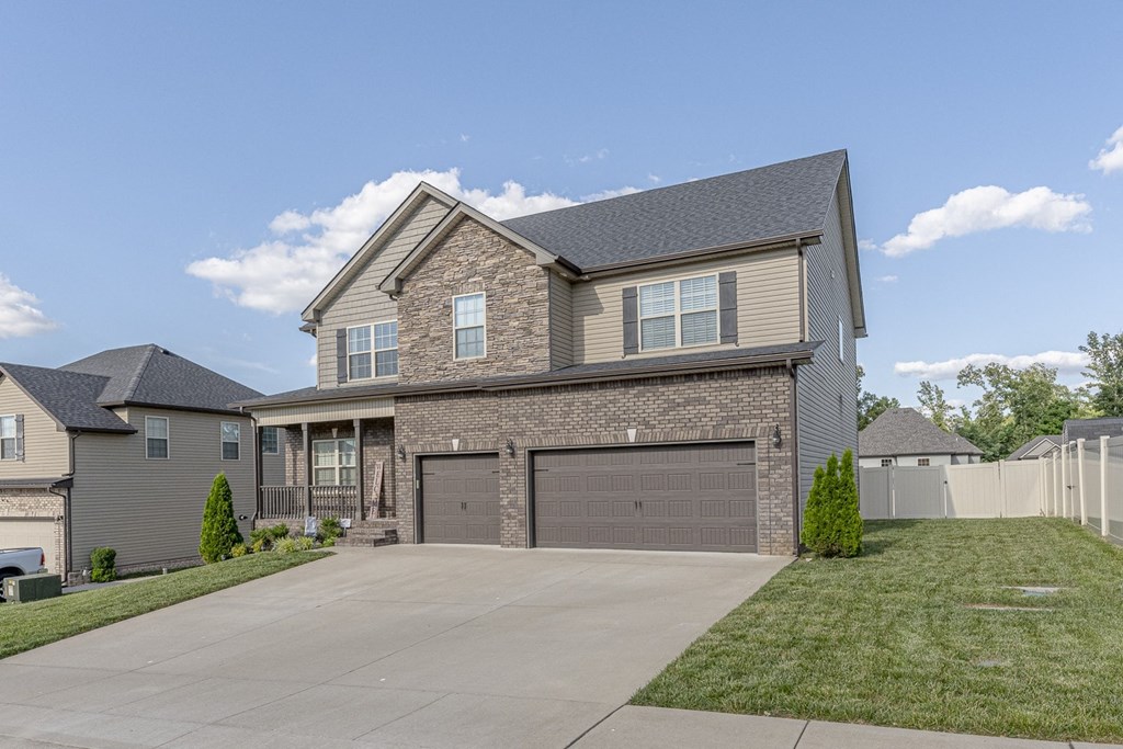 a large brick house with a garage and a driveway