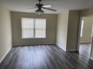 an empty living room with a ceiling fan