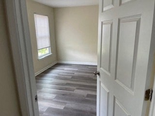 a room with wood floors and a white door
