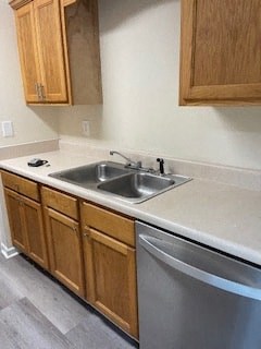 a kitchen with a stainless steel sink and wooden cabinets