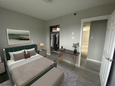 A bedroom with a large bed and a painting on the wall.