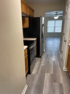 a kitchen with a black stove and a refrigerator