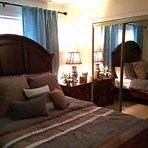 a bedroom with a large bed and a mirror