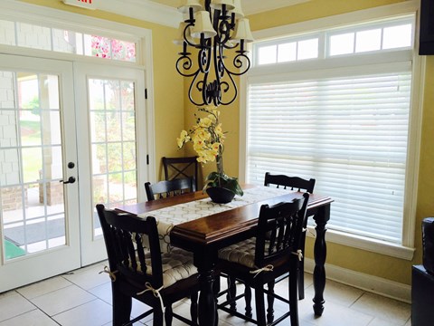 a dining room with a table and chairs and a chandelier