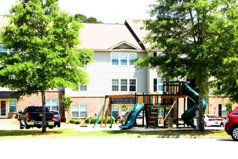 a childrens playground in front of a house