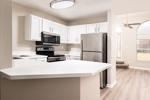a kitchen with a counter top and a refrigerator